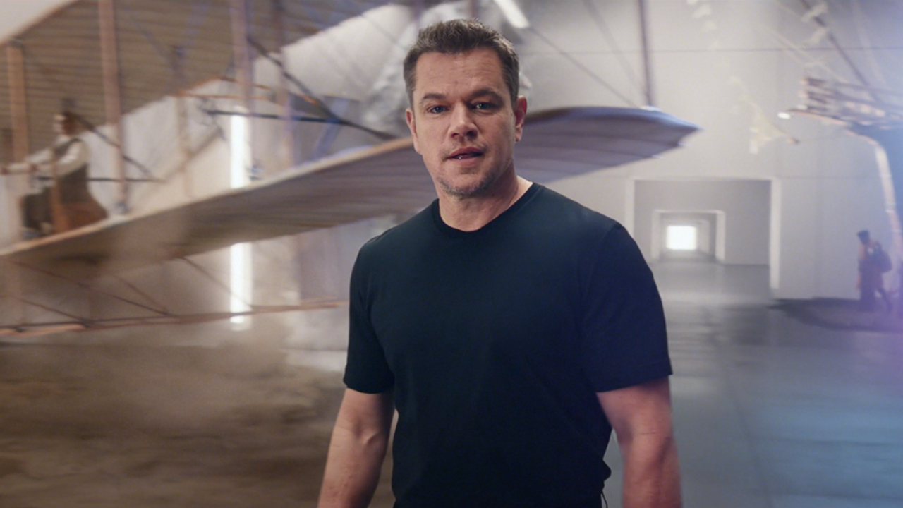 Matt Damon in front of a bi-plane.